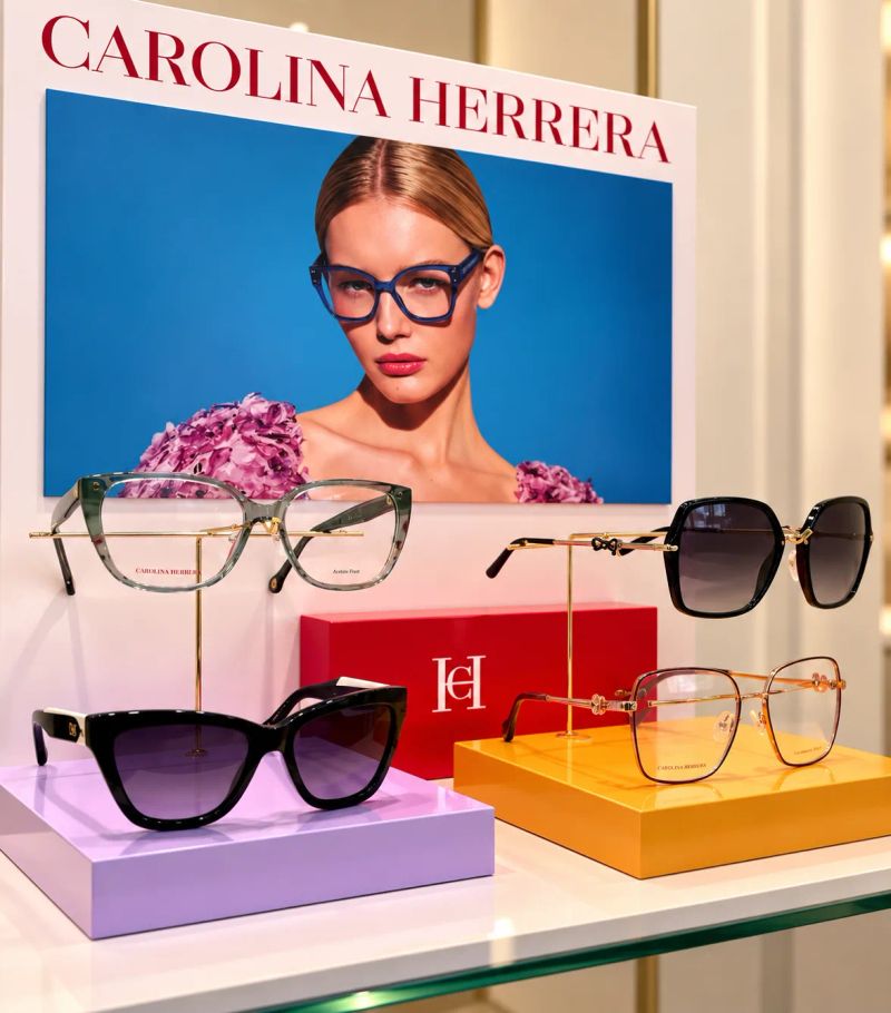 Display of Carolina Herrera sunglasses and glasses at F.Y. EYE Optometry Center, featuring various stylish frames.